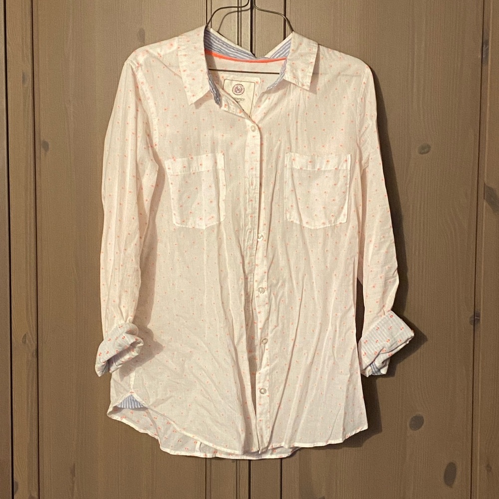 White button up blouse with coral colored dots and light blue embellishments